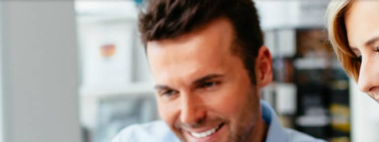 A man with a beard smiling for the camera.