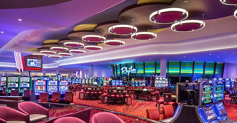 Casino interior with slot machines and tables.
