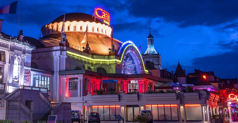 Colorful casino building illuminated at night.